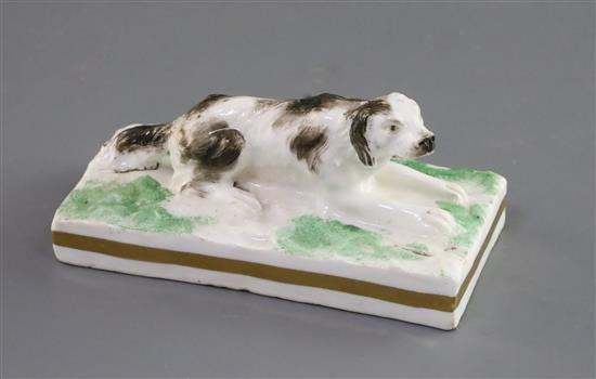 A Rockingham porcelain figure of a recumbent setter, c.1830, L. 10.9cm